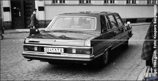 1986.oktobris. Rīga. Pirmā „GAZ 14” Latvijā. Limuzīns no LSPR komunistiskās partijas garāžas. Numura zīme uz priekšējā pampera nav pat uzstādīta. Pavadošais automobilis „GAZ 24” no Valsts drošības komitejas (KGB).  Šāda eskorta pavadībā uz Doma baznīcu, klausīties ērģeļmūzijas koncertu tika atvests kāds augsta ranga kompartijas „čiekurs” no Maskavas. 
Foto no Kaspara Bergmaņa arhīva.

